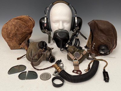 Lot 762 - Two leather flying caps; two oxygen/...