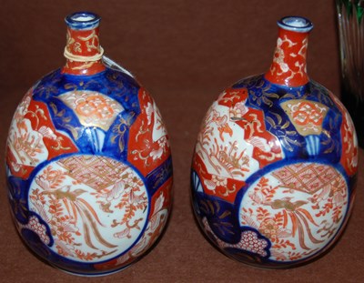Lot 21 - A pair of Japanese Imari porcelain bottle...