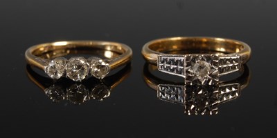 Lot 94 - A white and yellow metal three stone diamond...