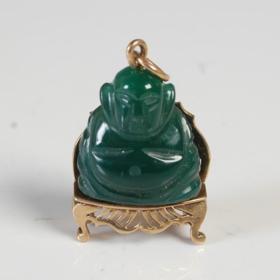Lot 99 - A 9ct gold mounted green carved stone buddha...