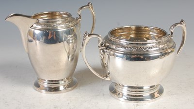 Lot 159 - A Sheffield silver milk jug and matching twin...