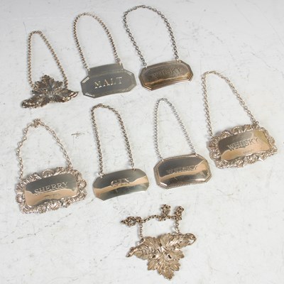 Lot 172 - Seven assorted silver spirit labels, and an...