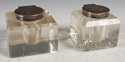 Lot 187 - Two silver mounted clear glass inkwells of...