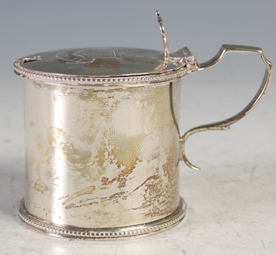 Lot 224 - A London silver mustard pot, the hinged cover...