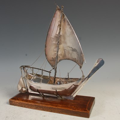 Lot 232 - A Middle Eastern white metal model of a Dhow,...