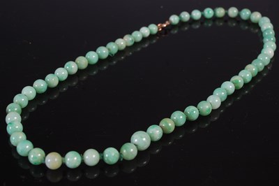 Lot 239 - A jade bead necklace, approximately 51cm long,...