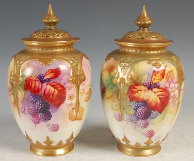 Lot 256 - A pair of Royal Worcester urns and covers,...