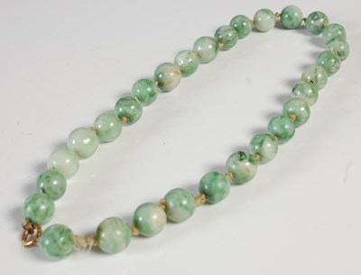 Lot 283 - An antique strand of jade beads, varying...