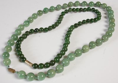 Lot 294 - Two green stone bead necklaces.