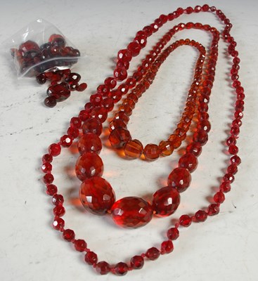 Lot 295 - Three facetted amber type bead necklaces and a...