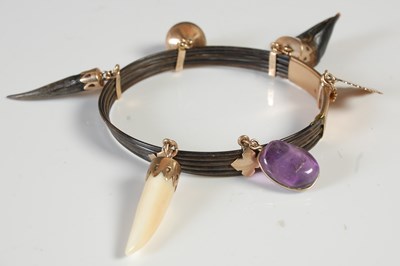 Lot 353 - A Kenyan yellow metal mounted bracelet,...