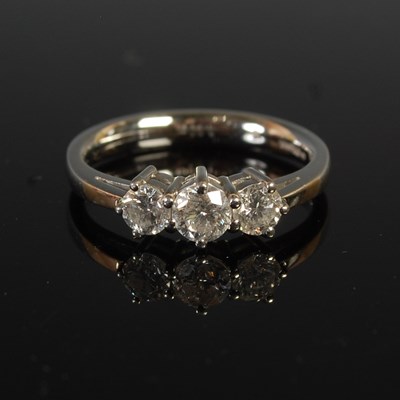Lot 357 - A platinum and diamond three stone ring, the...