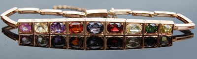 Lot 41 - A yellow metal and multi-gem set bracelet, set...