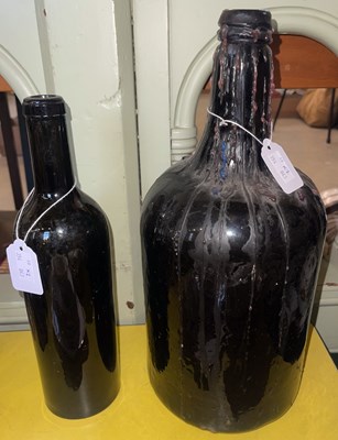 Lot 542 - Two vintage green tinted glass bottles, the...