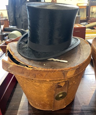 Lot 568 - A vintage top hat in leather carry case.