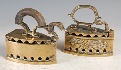 Lot 619 - Two antique brass irons, one with wooden...