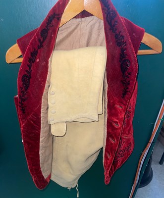 Lot 746 - A red velvet waistcoat and pair of yellow...