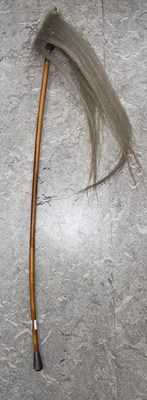 Lot 751A - A white metal mounted fly swat.