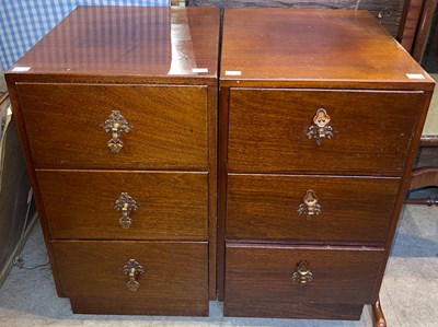 Lot 866 - A pair of mahogany three drawer bedside chests,...