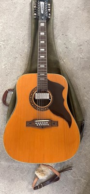 Lot 880 - An Eko acoustic guitar and leatherette sleeve.