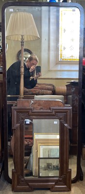 Lot 907 - A free-standing rounded rectangular mirror,...