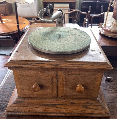 Lot 913 - A vintage blonde oak gramophone by HMV.