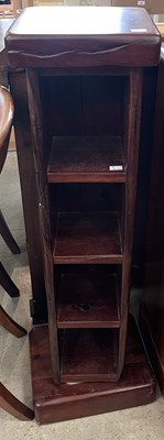 Lot 790 - A darkwood revolving stand fitted with four...