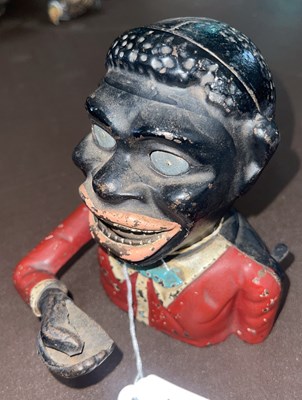 Lot 648 - A cast iron figural money bank, 15cm high.