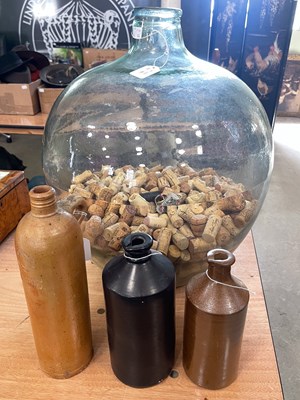 Lot 950 - A green tinted glass Carboy jar, containing a...
