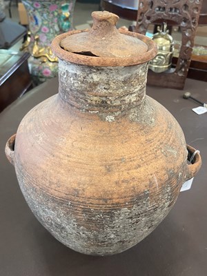 Lot 374 - An antique terracotta pottery twin handled jar...