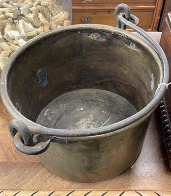 Lot 951 - A brass pail with a cast iron swing handle,...