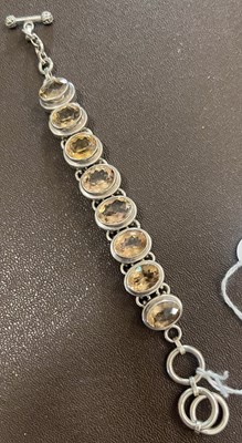 Lot 52 - A white metal and gem set, probably citrine,...