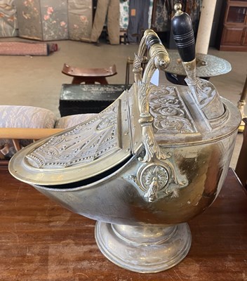 Lot 962 - An embossed brass helmet shaped coal scuttle...