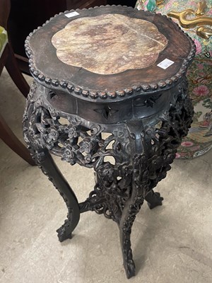 Lot 973 - A Chinese darkwood shaped circular urn stand,...