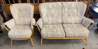 Lot 981 - An Ercol blond wood two seat sofa together...