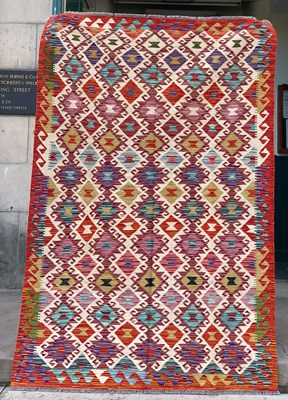 Lot 997 - A Chobi Kilim rug, the ivory coloured ground...