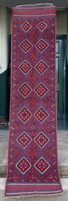Lot 886 - A Meshwani runner, the madder and blue ground...