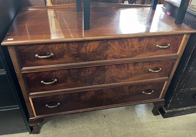 Lot 910 - A mahogany chest of three long drawers with...