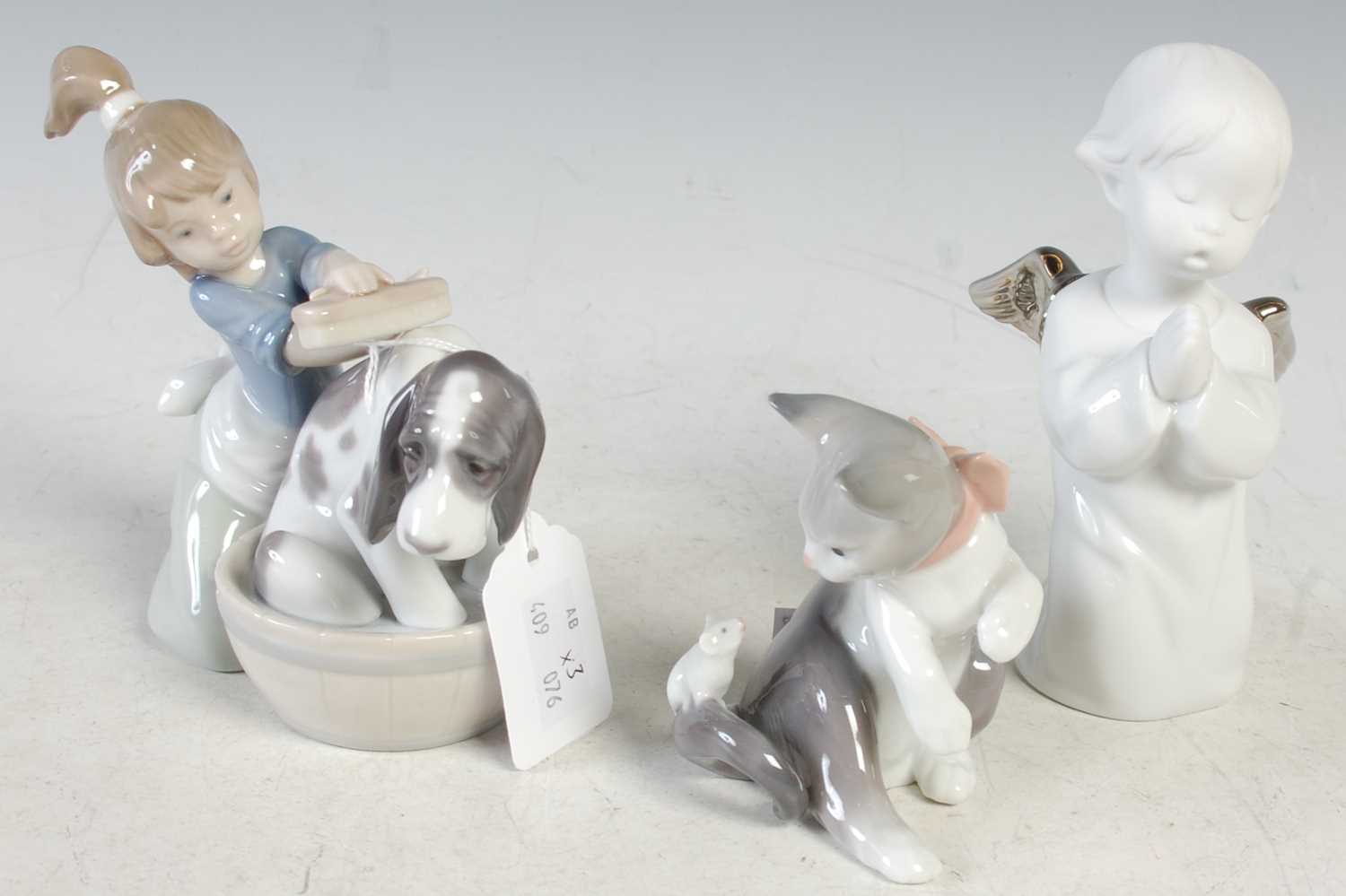 Lot 14 - A group of three Lladro porcelain figures to...