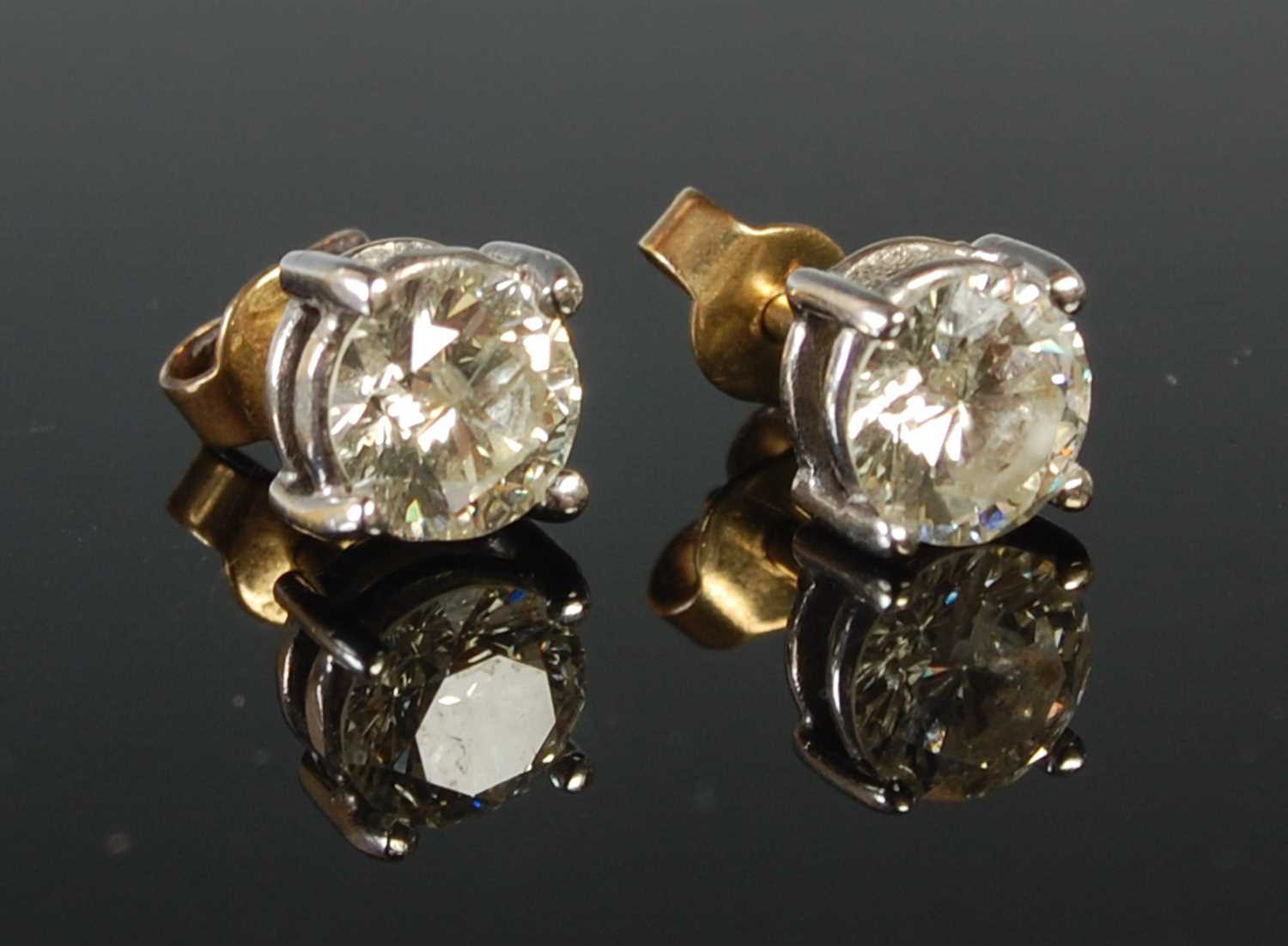 Lot 53 - A pair of white and yellow metal diamond stud...