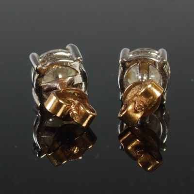 Lot 53 - A pair of white and yellow metal diamond stud...