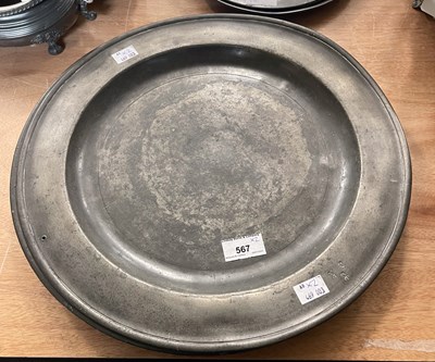 Lot 567 - An 18th century large pewter charger with...