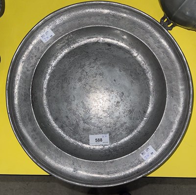 Lot 588 - An 18th century pewter charger with plain...