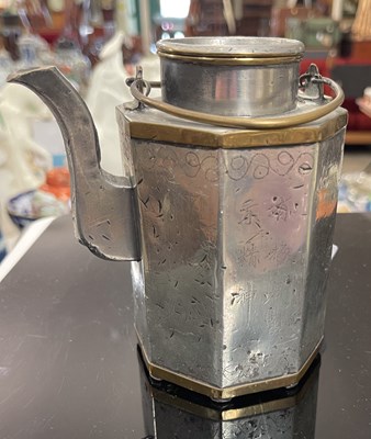 Lot 267 - A Chinese polished pewter octagonal teapot...