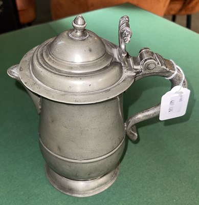 Lot 576 - An 18th century pewter baluster covered jug...