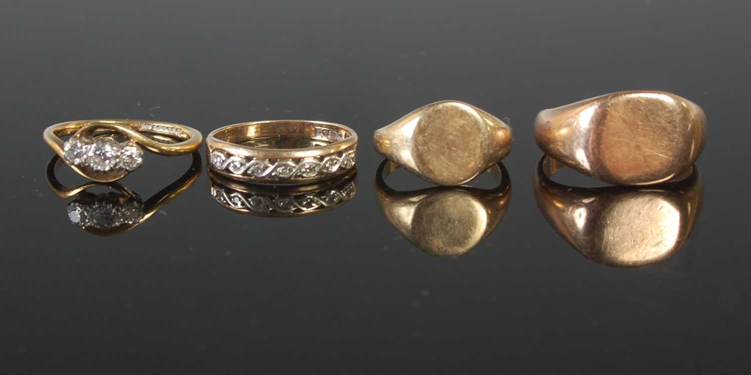 Lot 69 - A group of four yellow metal rings to include...