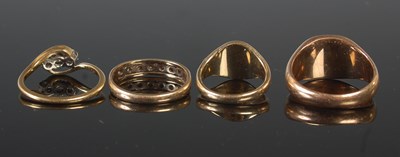 Lot 69 - A group of four yellow metal rings to include...