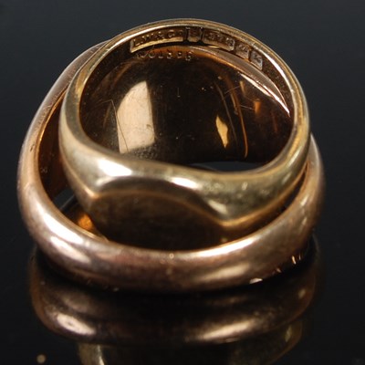 Lot 69 - A group of four yellow metal rings to include...