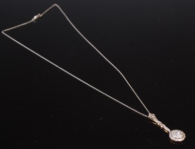 Lot 79 - A yellow and white metal diamond set pendant...