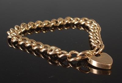 Lot 88 - A yellow metal curb link bracelet stamped...